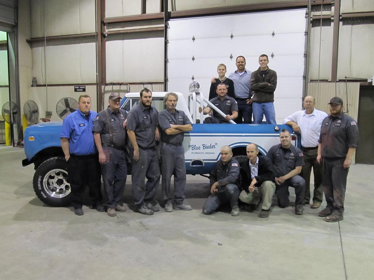 CEO & Owner Tom Wiers with his 2 sons and the Plymouth Body Shop crew in 2011.